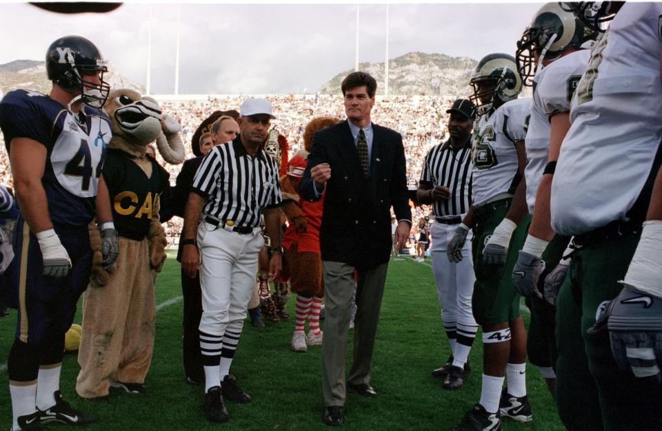 Commissioner Craig Thompson tosses the coin before the Mountain West's first football game on Sept. 16, 1999, between CSU and BYU. The Cougars won the game, played in Provo, Utah, 34-13.