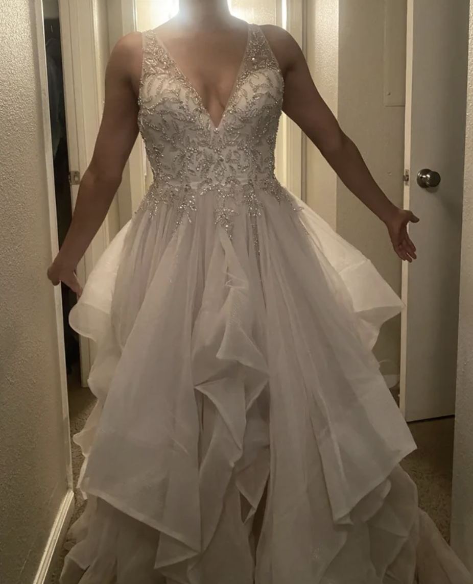 A woman trying on a wedding dress