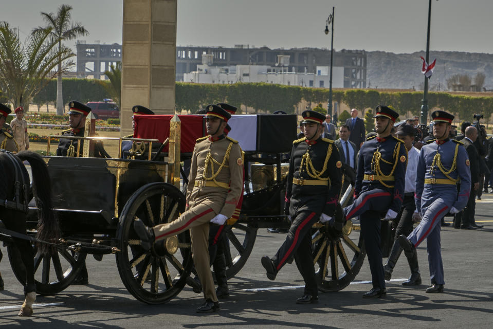 A horse-drawn carriage carries the flag-draped coffin of former autocratic President Hosni Mubarak during his funeral, at Tantawi Mosque, in eastern Cairo, Egypt, Wednesday, Feb. 26, 2020. Egypt is holding a full-honors military funeral for Mubarak who was ousted from power in the 2011 Arab Spring uprising. The 91-year-old Mubarak died on Tuesday at a Cairo military hospital from heart and kidney complications. (AP Photo/Hamada Elrasam)