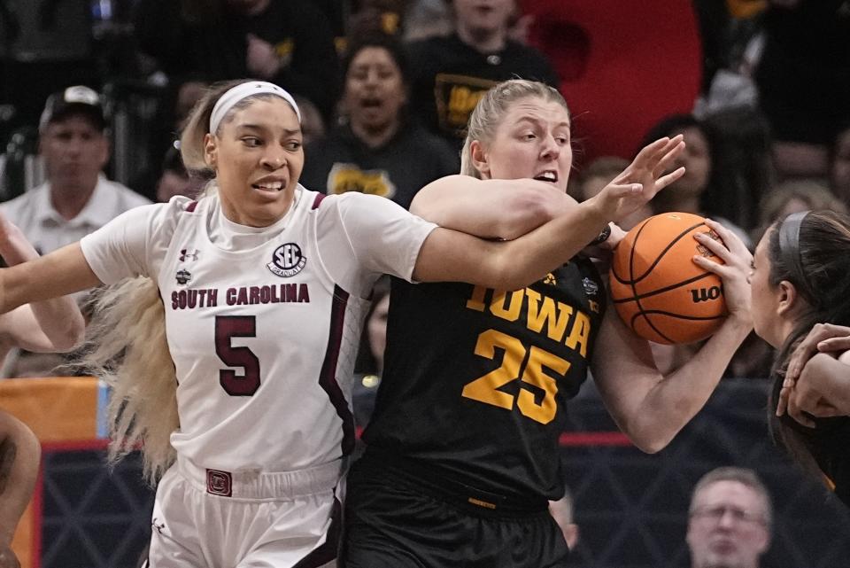 South Carolina's Victaria Saxton and Iowa's Monika Czinano go after a loose ball during the first half of an NCAA Women's Final Four semifinals basketball game Friday, March 31, 2023, in Dallas. (AP Photo/Darron Cummings)