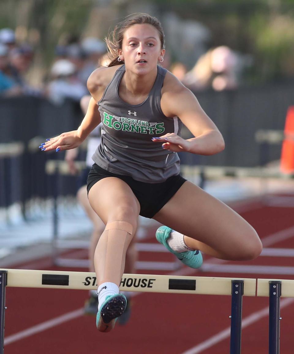 Maddie Miller of Highland runs to a first place finish with a time of 47.37 seconds in the 300 meter hurdles during the Suburban League American Conference Meet at Tallmadge High School in Tallmadge on Tuesday. 