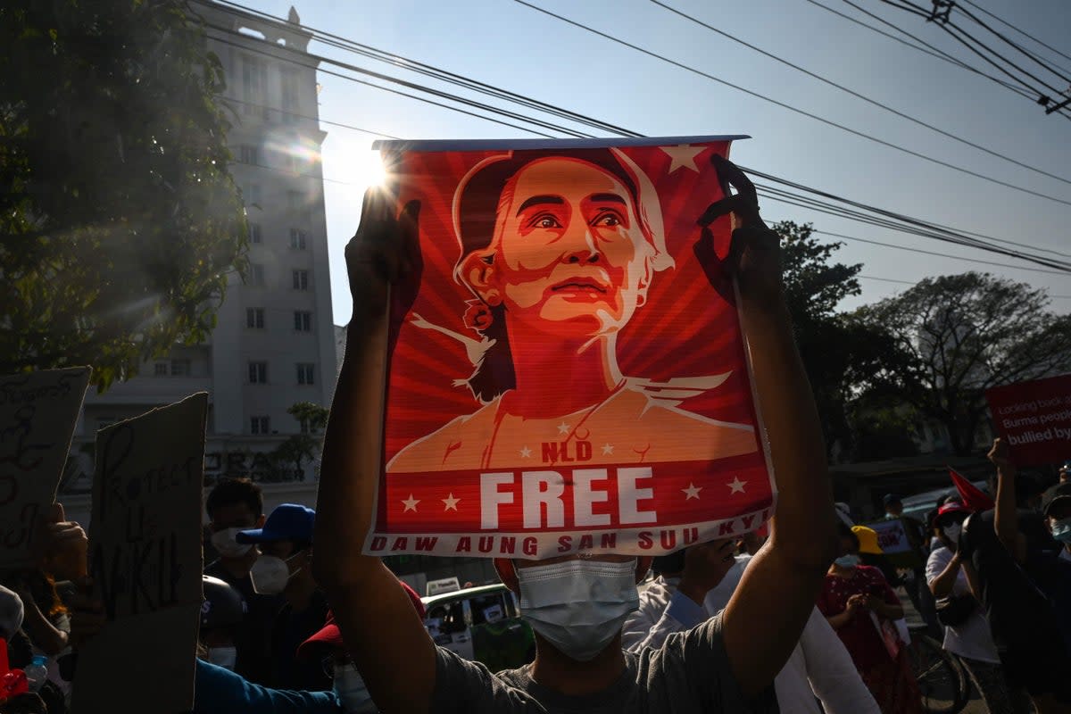 A protester holds up a poster featuring Aung San Suu Kyi during a demonstration against the military coup at in front of the Central Bank of Myanmar in Yangon on February 15, 2021 (AFP via Getty Images)
