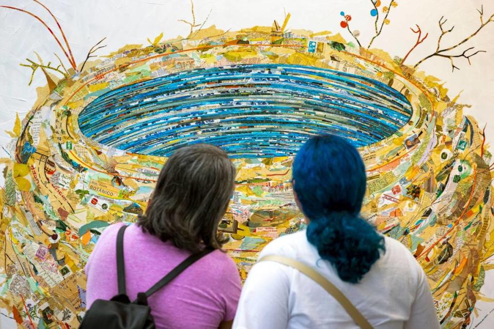 Dos asistentes observan una obra de arte durante el Festival de las Artes de Coconut Grove 2022.