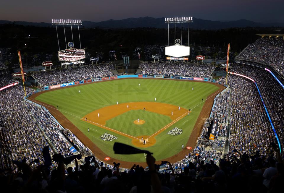 FILE - In this Oct. 25, 2017, file photo, the Houston Astros and the Los Angeles Dodgers play in Game 2 of the baseball World Series at Dodger Stadium in Los Angeles. Dodger Stadium’s 40-year wait to host the All-Star Game is going to last even longer. The game scheduled for July 14 was canceled Friday, July 3, 2020, because of the coronavirus pandemic, and Dodger Stadium was awarded the 2022 Midsummer Classic. (AP Photo/Tim Donnelly, File)
