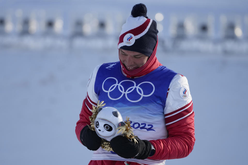 Silver medal finisher Russian athlete Alexander Bolshunov reacts during a venue ceremony after the men's weather-shortened 50km mass start free cross-country skiing competition at the 2022 Winter Olympics, Saturday, Feb. 19, 2022, in Zhangjiakou, China. (AP Photo/Aaron Favila)