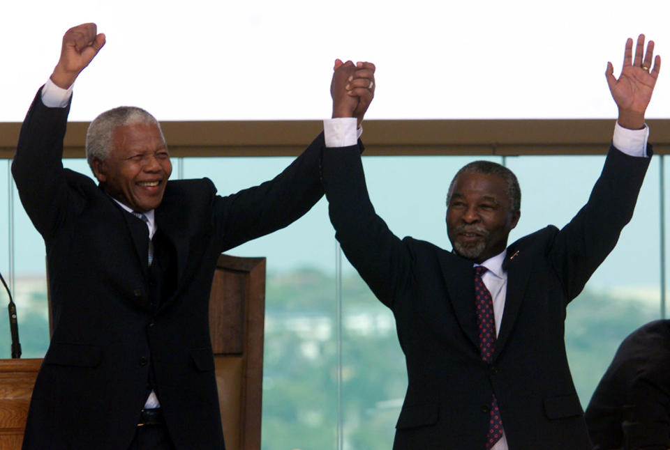 Former South African President Nelson Mandela (L) raises the hand of the new President, Thabo Mbeki after he took the oath of office at the Union Buildings in Pretoria June 16, 1999. South Africans and foreigners of all colours gathered on Wednesday morning to bid farewell to Mandela and welcome his sucessor Mbeki as South Africa's second democratically elected President. (Reuters)