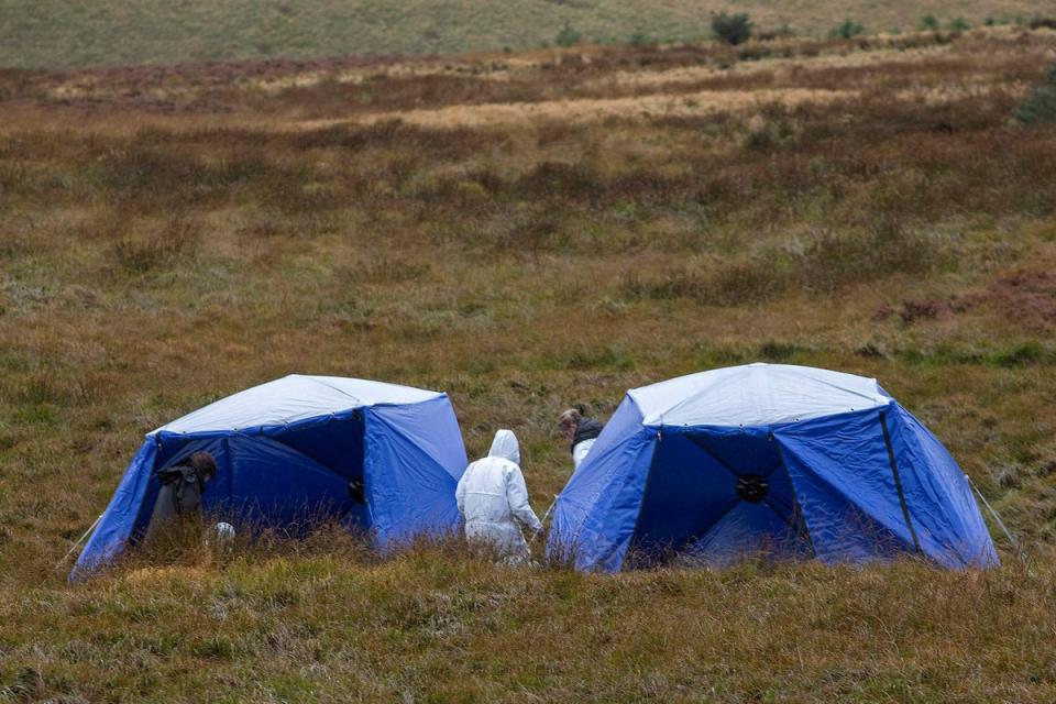 Police teams had to pause the work on Friday due to bad weather (AFP via Getty Images)