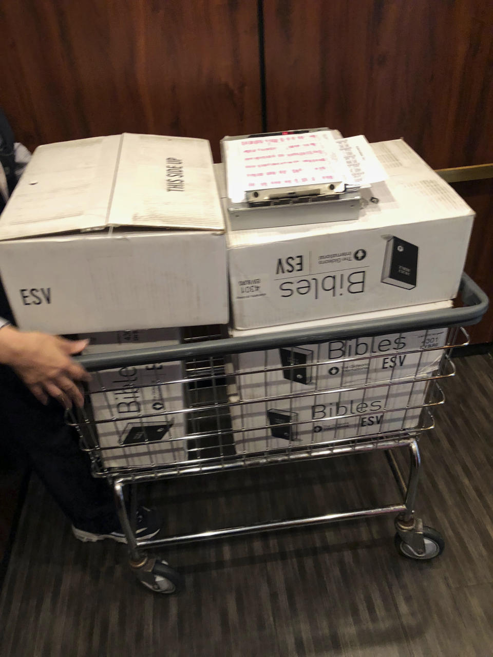 In this Aug. 10, 2018, photo provided by Tommy Danielsen boxes of Bibles sit in a cart at Sheraton Rockville Hotel in Rockville, Md. Marriott International, which bought Starwood two years ago, has begun putting copies of the Bible and the Book of Mormon in Sheratons, Westins and other hotels in the Starwood family. Marriott says it expects to place the books in 300,000 rooms by the end of this year. (Tommy Danielsen via AP)