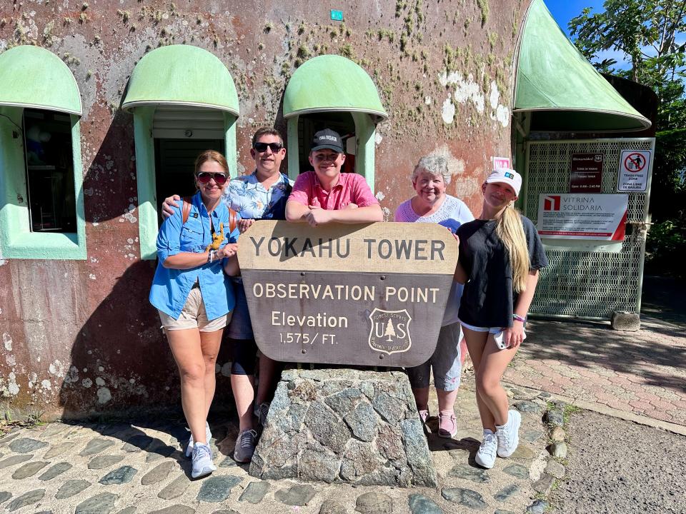 Terri Peters and her family outside standing by a sign that says Yokahu Tower Observation Point.