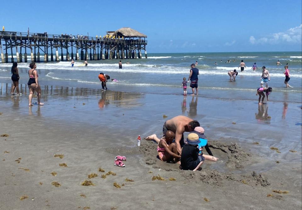 A number of people were in the water Friday afternoon near Cocoa Beach Pier.