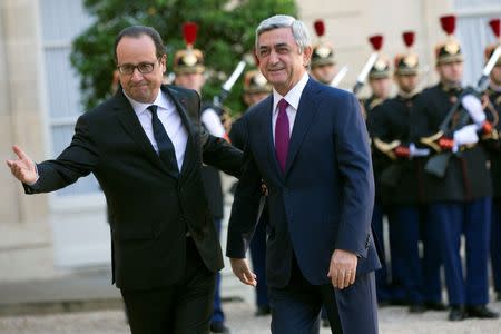 French President Francois Hollande (L) greets Armenian President Serzh Sarksyan as he arrives at the Elysee Palace in Paris, October 27, 2014. REUTERS/Philippe Wojazer