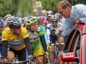 Christian Prudhomme (R), seen here talking to Lance Armstrong during the 92nd Tour de France, in 2005. Tour de France director Prudhomme said he was against re-attributing disgraced Armstrong's seven victories in the world's most prestigious cycling race