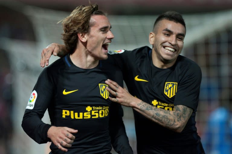 Atletico Madrid's Antoine Griezmann (L) celebrates with teammate Angel Correa after scoring during their Spanish La Liga match against Granada, at Nuevo Los Carmenes stadium in Granada, on March 11, 2017