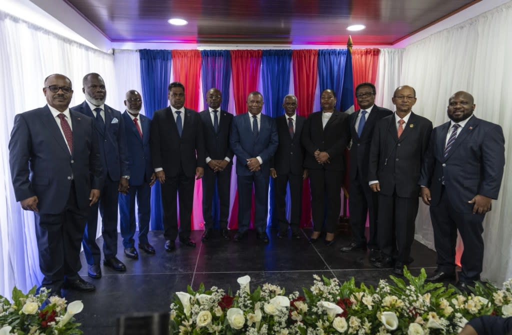 Ex-senator Louis Gerald Gilles, from left to right, pastor Frinel Joseph, barrister Emmanuel Vertilaire, businessman Laurent Saint-Cyr, interim Prime Minister Michel Patrick Boisvert, Judge Jean Joseph Lebrun, who is not a member of the council, former senate president Edgard Leblanc, Regine Abraham, former central bank governor Fritz Alphonse Jean, former diplomat Leslie Voltaire and former ambassador to the Dominican Republic Smith Augustin, pose for a group photo during an installation ceremony, in Port-au-Prince, Haiti, Thursday, April 25, 2024. (AP Photo/Ramon Espinosa)