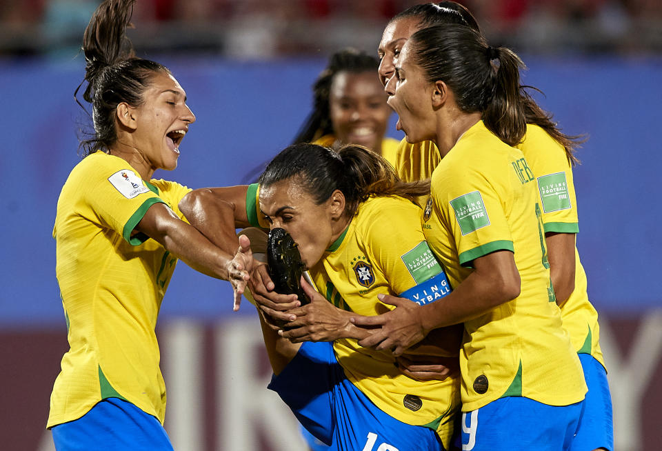 Marta kisses her own foot after scoring Brazil's first goal against Italy, which made her the all-time leading goal scorer in World Cup history. (Photo by Quality Sport Images/Getty Images)