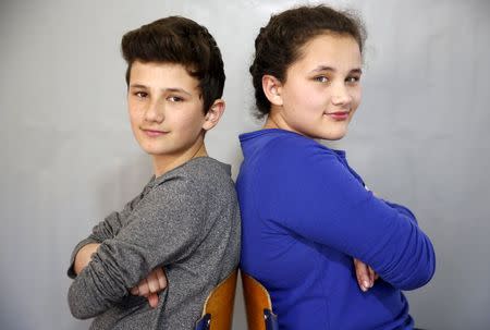 Twins Sara (R) and Samed Dizdarevic pose for a portrait at a primary school in Buzim April 10, 2015. REUTERS/Dado Ruvic