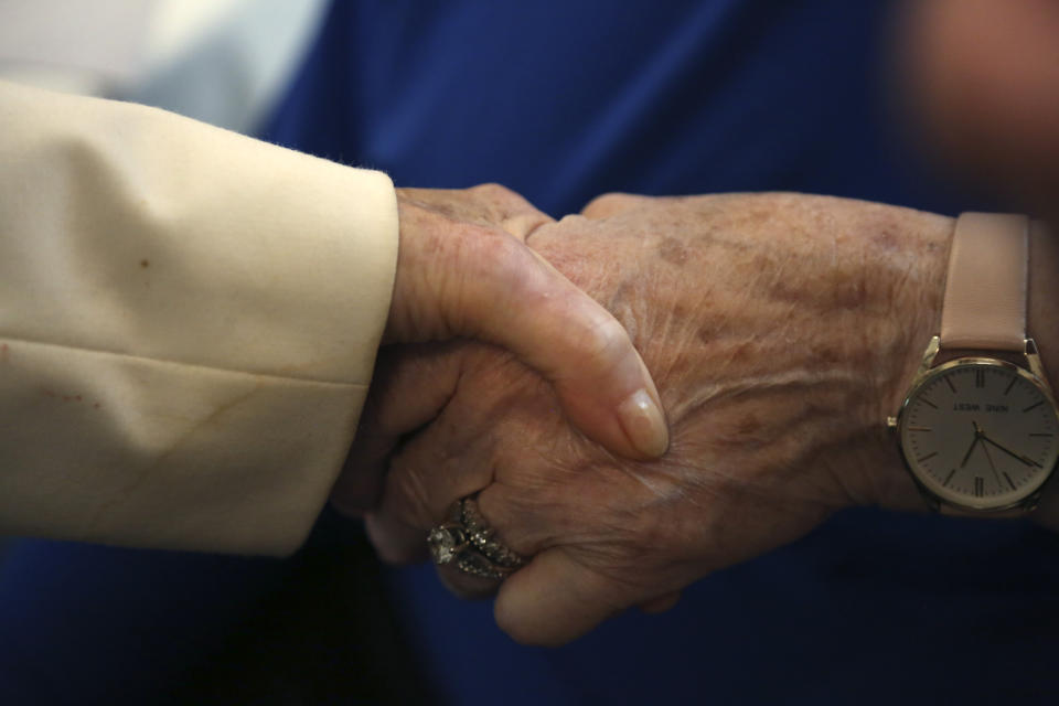 Holocaust survivors and friends Dolly Rabinowitz and Toby Goldberg hold hands as they talk about memories from World War II and their recent experiences with the coronavirus on Monday, June 14, 2021, at the Yeshivah of Flatbush theater at Joel Braverman High School in the Brooklyn borough of New York. The two women and dozens of other Holocaust survivors gathered for a concert honoring their lives and celebrating the end of their pandemic isolation. (AP Photo/Jessie Wardarski)