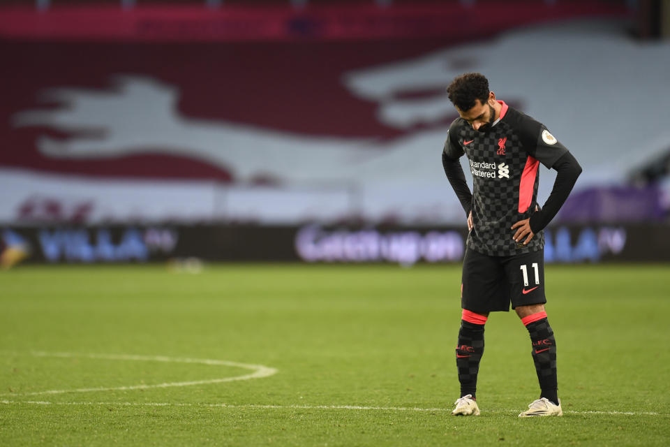 Liverpool's Mohamed Salah gestures after Aston Villa's Jack Grealish scores his side's sixth goal during the English Premier League soccer match between Aston Villa and Liverpool at the Villa Park stadium in Birmingham, England, Sunday, Oct. 4, 2020. (Peter Powell/Pool via AP)