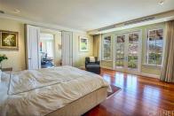<p>The master bedroom has plenty of natural light, his-and-hers closets, wood floors and access to a private balcony. (Trulia) </p>