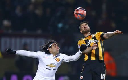 Manchester United's Radamel Falcao (L) challenges Cambridge United's Michael Nelson during their English FA Cup 4th round soccer match at The Abbey Stadium in Cambridge, eastern England January 23, 2015. REUTERS/Andrew Winning