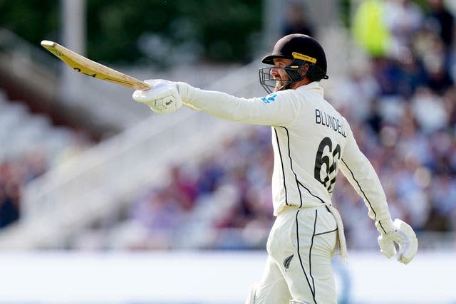 Tom Blundell raises his bat after reaching his century