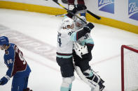 Seattle Kraken goaltender Philipp Grubauer, right, celebrates with defenseman Jamie Oleksiak as Colorado Avalanche right wing Mikko Rantanen heads off the ice as time runs out in the third period of Game 7 of an NHL first-round playoff series Sunday, April 30, 2023, in Denver. The Kraken won 2-1 to advance to the next round. (AP Photo/David Zalubowski)