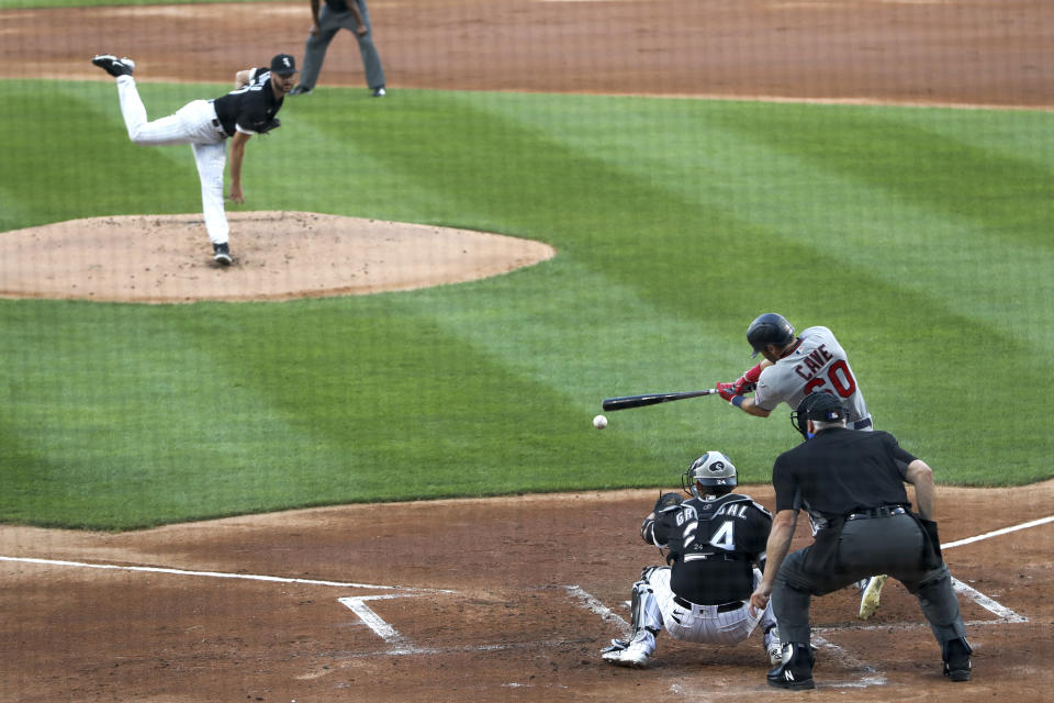 Minnesota Twins' Jake Cave hits a two-run single off Chicago White Sox starting pitcher Lucas Giolito, during the first inning of a baseball game Friday, July 24, 2020, in Chicago. (AP Photo/Charles Rex Arbogast)