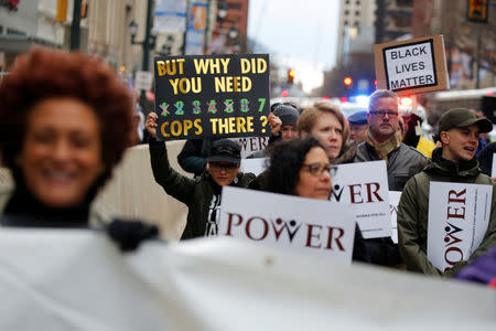 Protesters march down Market Street in Philadelphia, a week after two black men were arrested at a Starbucks coffee shop, in Philadelphia, Pennsylvania, U.S. April 19, 2018. REUTERS/Dominick Reuter