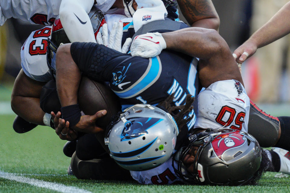 Carolina Panthers quarterback Cam Newton is sacked by Tampa Bay Buccaneers nose tackle Vita Vea (50) and defensive end Ndamukong Suh during the second half of an NFL football game Sunday, Dec. 26, 2021, in Charlotte, N.C. (AP Photo/Jacob Kupferman)