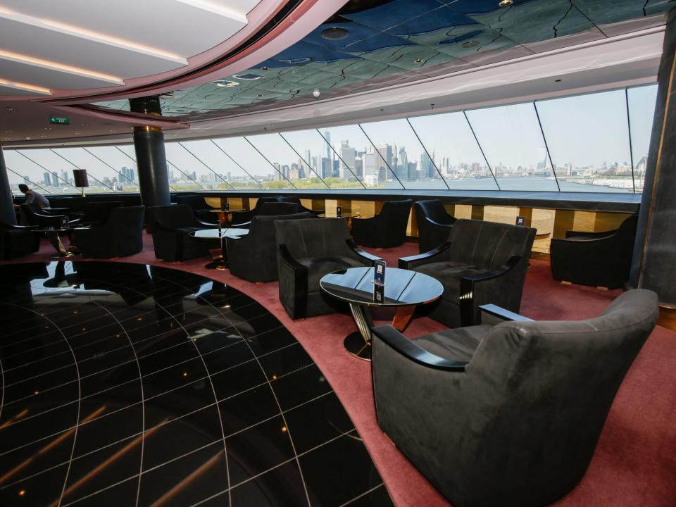 An empty lounge with views of the NYC skyline in the MSC Meraviglia