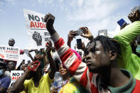 People hold banners as they demonstrate on the street to protest against police brutality in Lagos, Nigeria, Thursday Oct. 15, 2020. Protests against Nigeria's police continued to rock the country for the eighth straight day Thursday as demonstrators marched through the streets of major cities, blocking traffic and disrupting business. (AP Photo/Sunday Alamba)