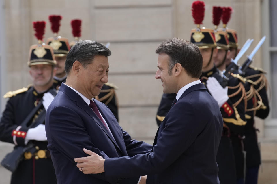 French President Emmanuel Macron, right, welcomes China's President Xi Jinping before their meeting at the Elysee Palace, Monday, May 6, 2024 in Paris. French President Emmanuel Macron is welcoming China's Xi Jinping for a two-day state visit to France and is seeking to press Xi to use his influence on Moscow to move toward ending the war in Ukraine. (AP Photo/Christophe Ena)