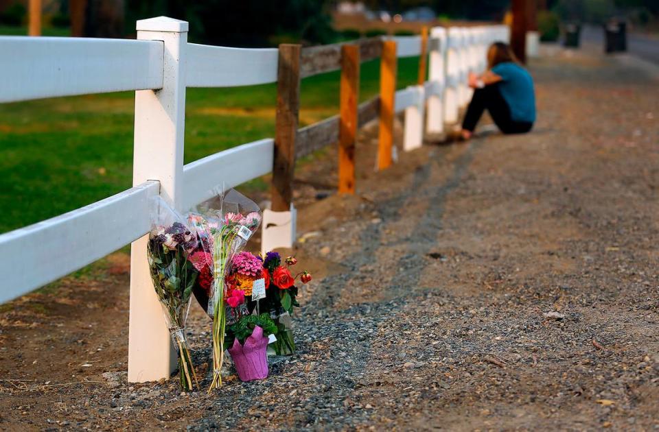 A woman visits the roadside memorial at the site of the Sept. 4 fatal crash on West Court Street in Pasco. Kennewick resident Shirley L. Nelson, 63, died after the 1933 Willys she was driving was hit by a Toyota Camry at Road 88.