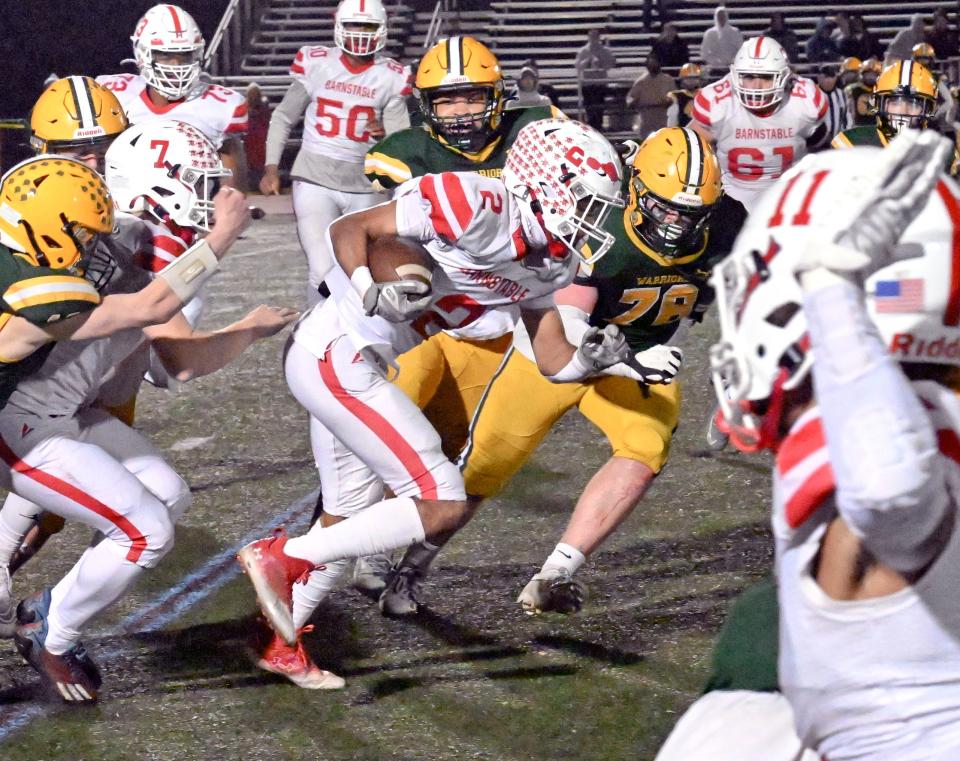 Tajardo France of Barnstable breaks through the line of King Philip Regional in football.