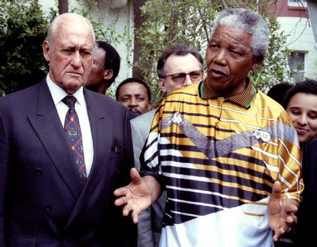 South African President Nelson Mandela speaks next to FIFA President Joao Havelange (L) in South Africa January 12, 1996.