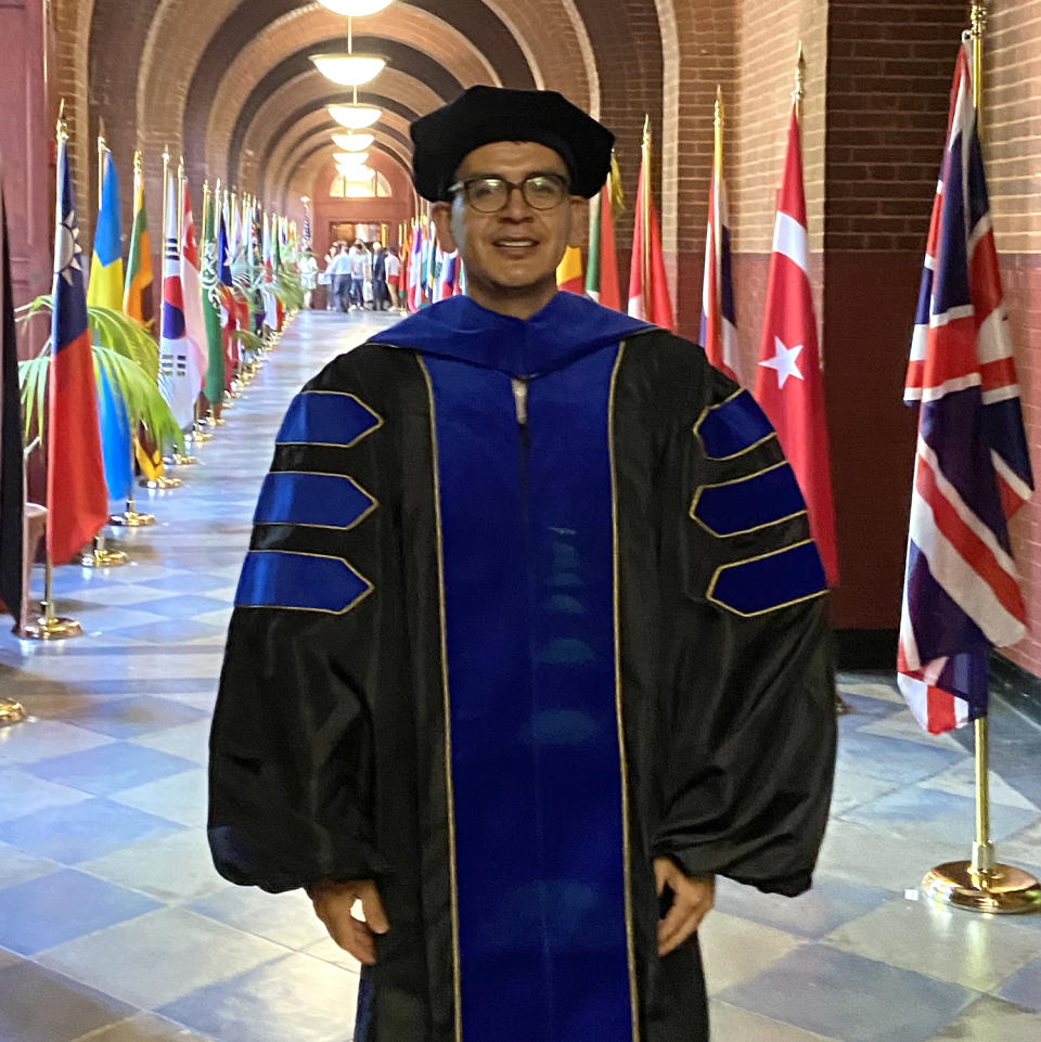 Abel Cruz Flores wearing his regalia the day of his Ph.D. graduation from Georgetown University on May, 19. (Courtesy Ruby Juárez)