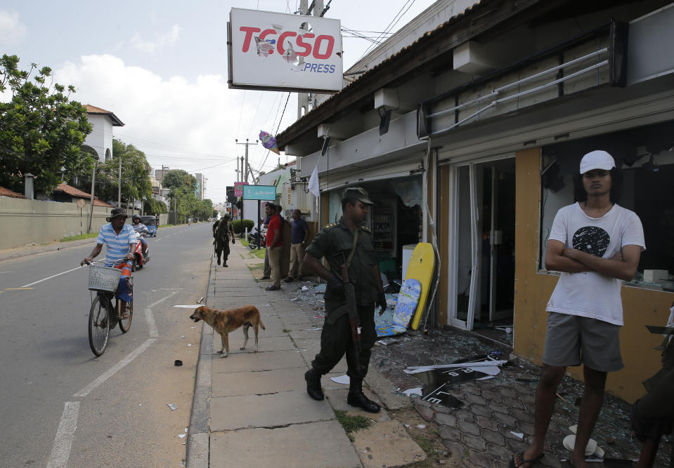 Sri Lankan army soldiers secure the area around vandalized properties owned by Muslims following an overnight clash with Christians in Poruthota, a village in Negombo, about 35 kilometers North of Colombo, Sri Lanka, Monday, May 6, 2019. Two people have been arrested and an overnight curfew lifted Monday after mobs attacked Muslim-owned shops and some vehicles in a Sri Lankan town where a suicide bombing targeted a Catholic church last month. Residents in the seaside town of Negombo say the mostly-Catholic attackers stoned and vandalized shops. It is unclear how the dispute began but most residents say a private dispute took a religious turn. (AP Photo/Eranga Jayawardena)