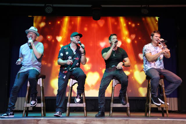 <p>Alexander Tamargo/Getty</p> Justin Jeffre, Drew Lachey, Jeff Timmons and Nick Lachey perform on stage during the 98 Degrees Ultimate Throwback Concert at Beaches Turks & Caicos Resort Villages & Spa