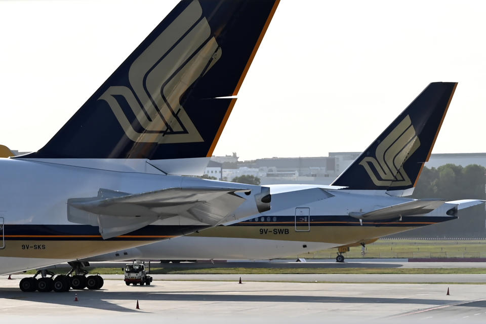 This photograph taken on March 16, 2020 shows Singapore Airlines planes parked on the tarmac at Changi International Airport in Singapore. - Singapore Airlines announced on March 23 that it was cutting 96 per cent of its capacity till the end of April due to the COVID-19 novel coronavirus. (Photo by Roslan RAHMAN / AFP) (Photo by ROSLAN RAHMAN/AFP via Getty Images)