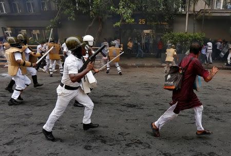 A police officer uses a tear gas gun to disperse the supporters of India’s Bharatiya Janata Party (BJP) during a protest against what the supporters call a breakdown of law and order in the state of West Bengal, in Kolkata, India May 25, 2017. REUTERS/Rupak De Chowdhuri