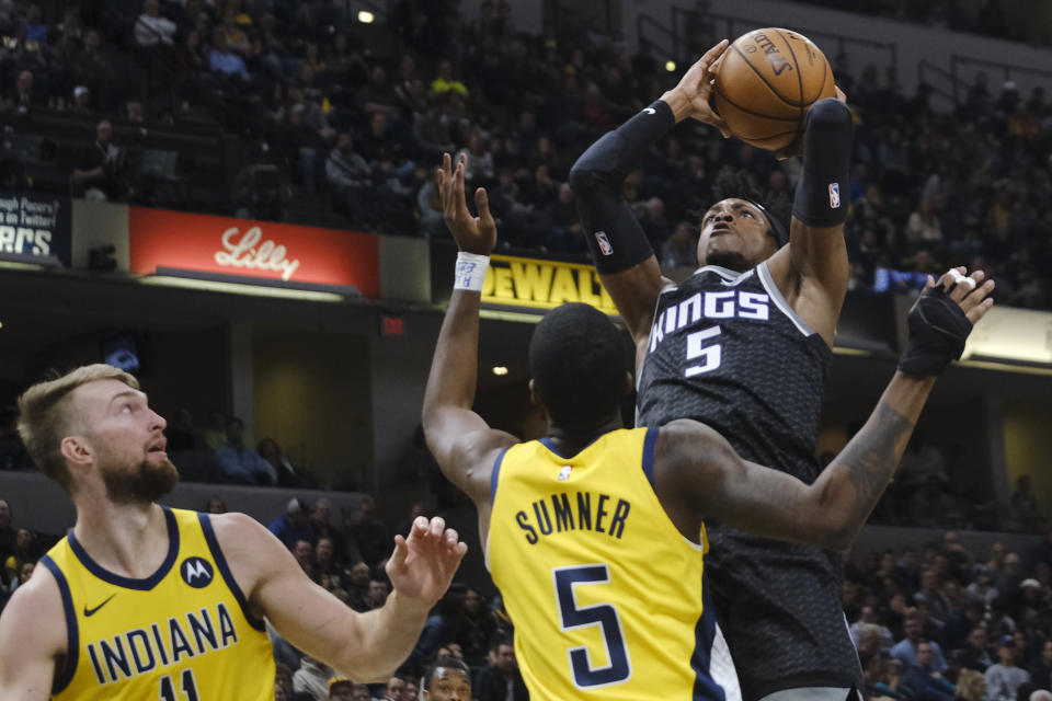 Sacramento Kings guard De'Aaron Fox, right, shoots over Indiana Pacers guard Edmond Sumner (5) during the first half of an NBA basketball game in Indianapolis, Friday, Dec. 20, 2019. (AP Photo/AJ Mast)