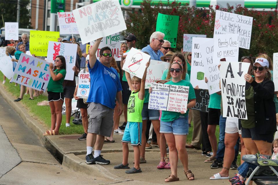 In Jefferson County, Kentucky, parents and others protest the school district's mask mandate before the start of a school board meeting in August.