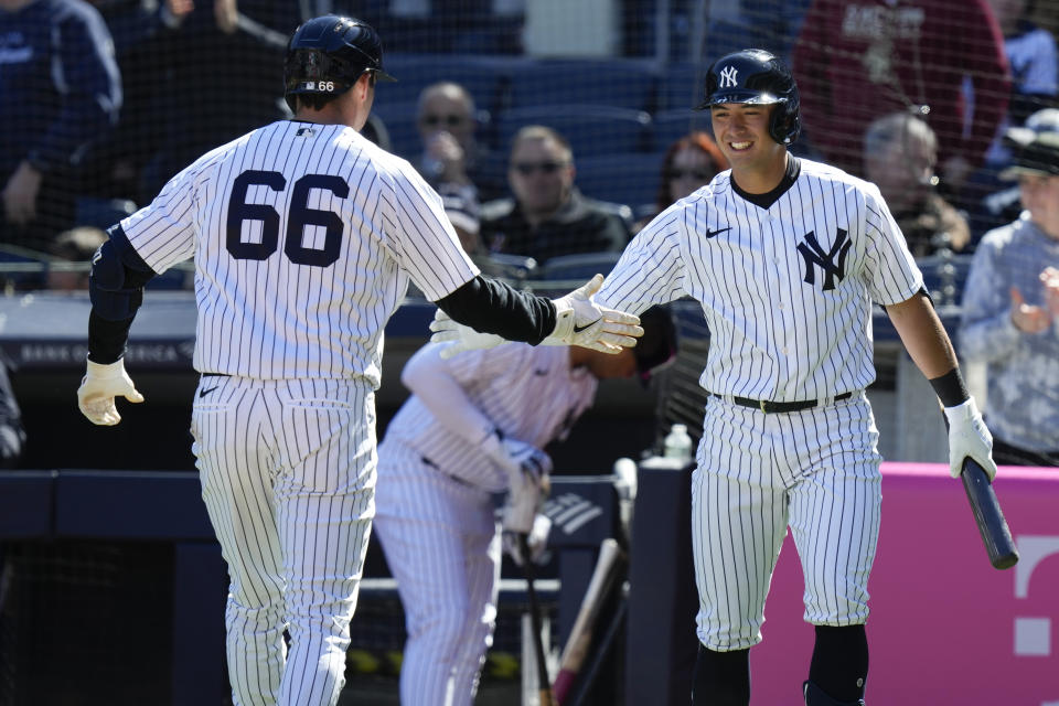 New York Yankees' Anthony Volpe, right, greets Kyle Higashioka (66) after Higashioka hit a home run during the fourth inning of the baseball game against the San Francisco Giants at Yankee Stadium, Sunday, April 2, 2023, in New York. (AP Photo/Seth Wenig)