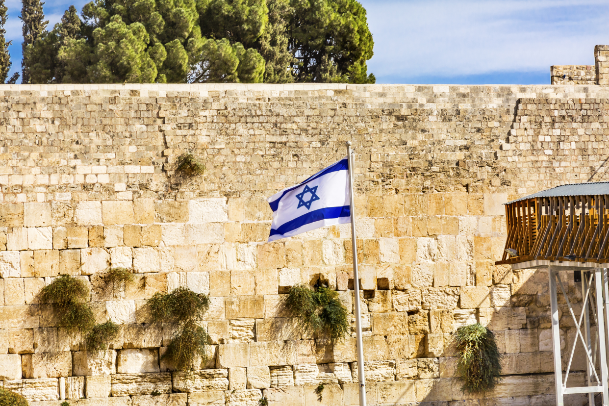 Israel flag in front of a wall