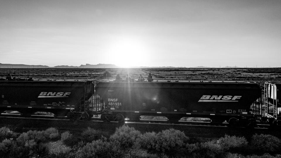 Migrants, a lucky few who managed to avoid detection by Mexican police, ride atop a train car headed to Ciudad Juárez on Sept. 24, 2023. The train only carried a dozen people, a big contrast from the hundreds who had gotten on top of trains in the previous days.