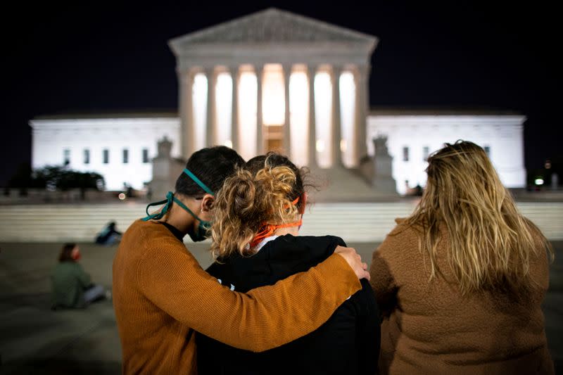 People stand in front of the U.S. Supreme Court following the death of U.S. Supreme Court Justice Ruth Bader Ginsburg, in Washington