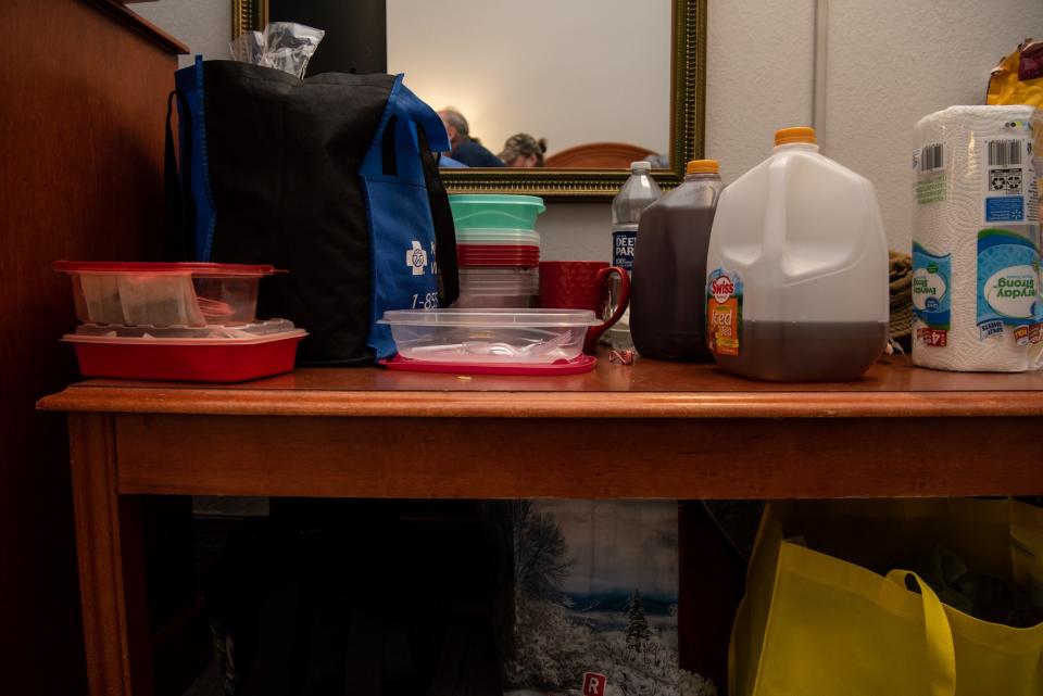 Food and other pantry items line a table in a hotel room occupied by Ron Salamanca and Christine Hendricks, who were displaced from The Bush House Hotel last month after the building was condemned for numerous health and safety violations.