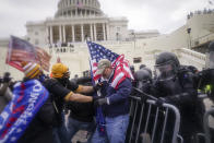 FILE - In this Jan. 6, 2021, file photo rioters try to break through a police barrier at the Capitol in Washington. (AP Photo/John Minchillo, File)