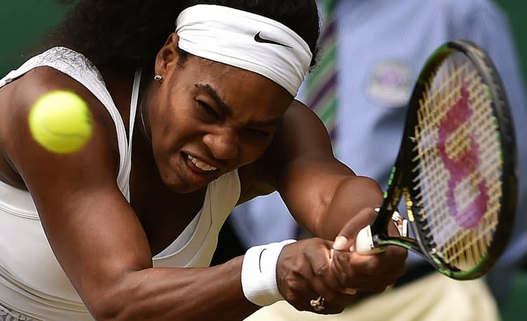US player Serena Williams hits a return against her sister Venus Williams during their fourth round match at the Wimbledon Championships at The All England Tennis Club in southwest London, on July 6, 2015