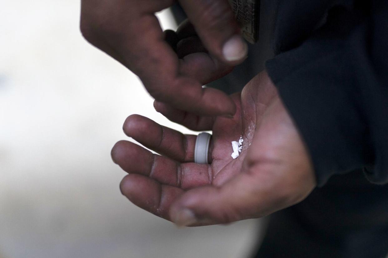 Pieces of fentanyl in the palm of a hand.